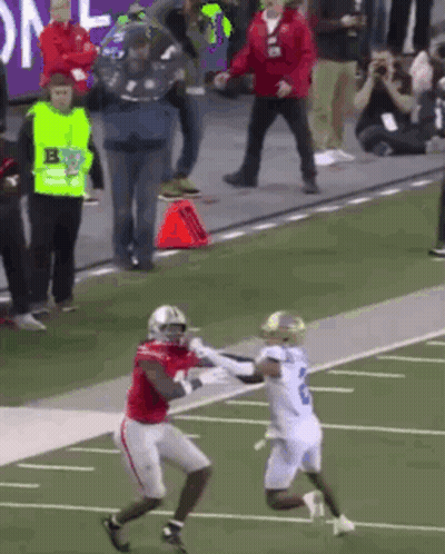 Football Player In Red Jersey Catching Pass From Player In White GIF