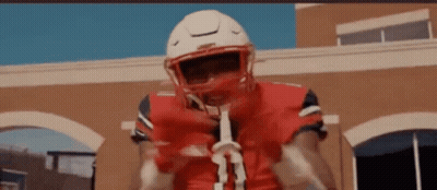Football Player In Red Jersey Holding Stick GIF
