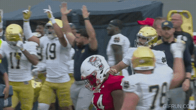 Football Player In Red Jersey Number 4 Surrounded By Other Players GIF