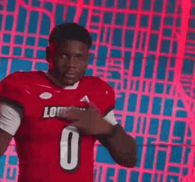 Football Player in Red Jersey Pointing at Chest
