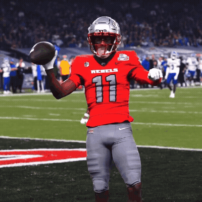 Football Player In Red Rebels Jersey Holding Football GIF