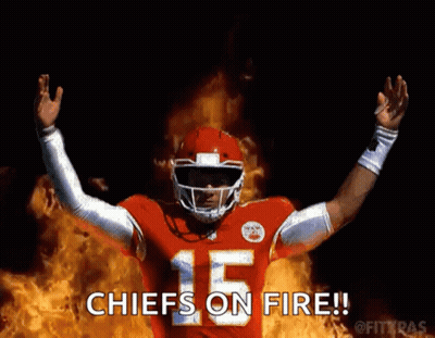Football Player In Red Uniform Standing In Front Of Fire GIF