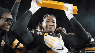 Football Player In SEC Jersey Holding Yellow Trophy GIF