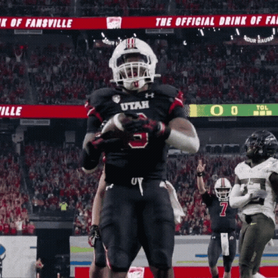 Football Player in Utah Jersey Holding Football