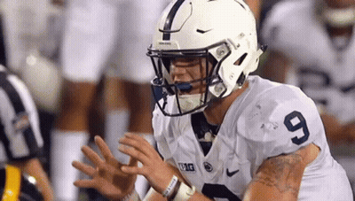 Football Player In White Helmet 9 Jersey Sitting On Field With Hands Outstretched GIF