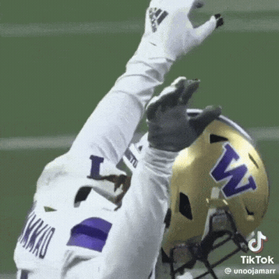 Football Player In White Jersey And Purple Helmet Reaching Up GIF