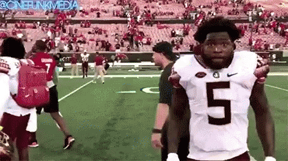 Football Player In White Jersey Number 5 Standing On Field GIF