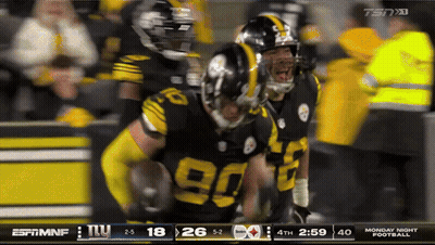 Football Player In Yellow Helmet In Front Of Scoreboard GIF