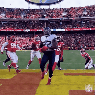 Football Player Jumping Holding Ball GIF