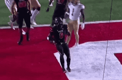 Football Player Jumping Holding Football GIF