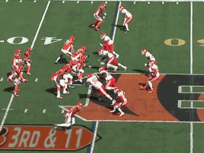 Football Player Kicking Ball With Referee Watching GIF