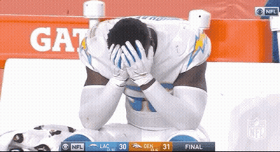 Football Player Kneeling Hands On Head In Front Of Gatorade Sign GIF