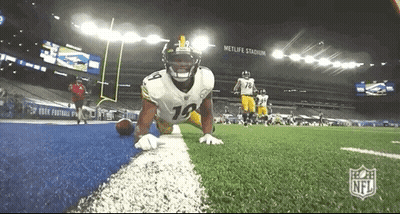 Football Player Kneeling Holding Football GIF