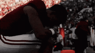 Football Player Kneeling In Crowded Stadium GIF