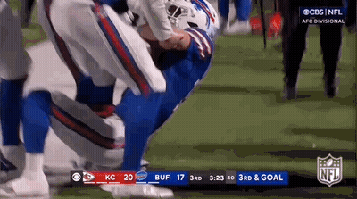 Football Player Kneeling on Field During Game