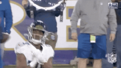 Football Player Kneeling With Cameraman Behind GIF