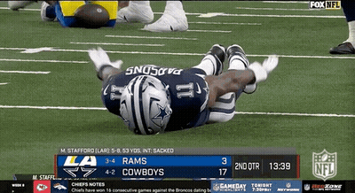 Football Player Laying On Field During Game GIF