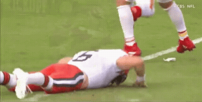 Football Player Laying On Field Head Down GIF