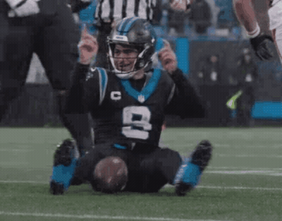 Football Player Laying On Field With Feet Up GIF