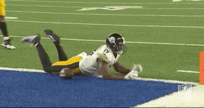 Football Player Lying On Field With Ball GIF