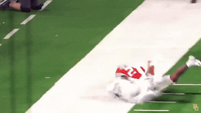 Football Player Lying On Field With Letter B On Jersey GIF