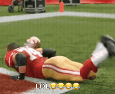 Football Player Lying On Field With LOL Face GIF