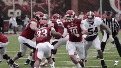 Football Player Number 10 Being Tackled GIF