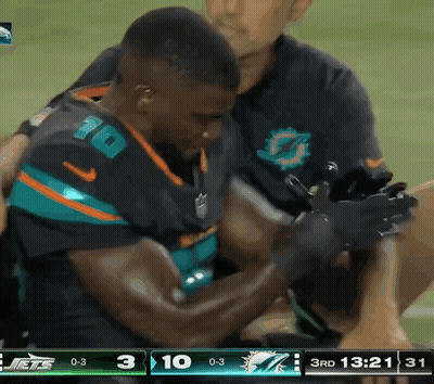 Football Player Number 10 Helped Off Field GIF