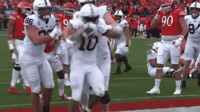 Football Player Number 10 Running With Teammates GIF
