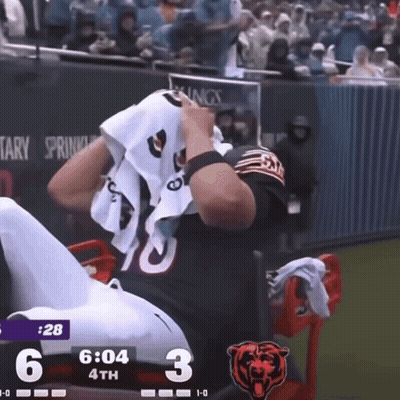 Football Player Number 10 Sitting on Bench