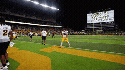 Football Player Number 10 Walking Off Field GIF