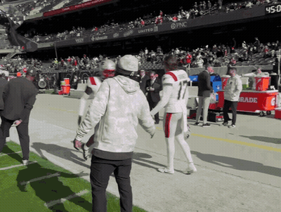 Football Player Number 11 Talking To Another Player GIF