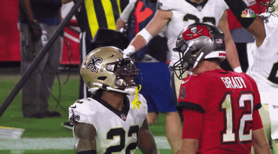 Football Player Number 12 Beside Another Player GIF