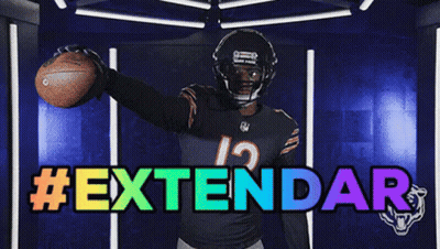 Football Player Number 12 Holding Football In Front Of Extendar Sign GIF