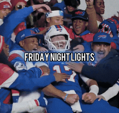 Football Player Number 12 Surrounded By Team GIF