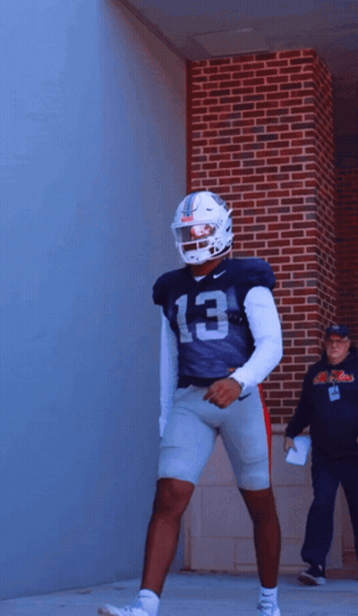Football Player Number 13 In Front Of Brick Wall GIF