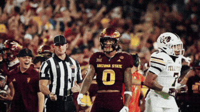 Football Player Number 14 Surrounded By Players GIF