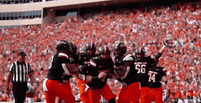 Football Player Number 14 Surrounded By Players GIF