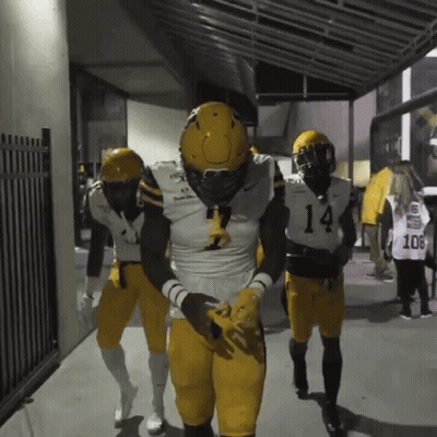 Football Player Number 14 Walking Down Hallway GIF