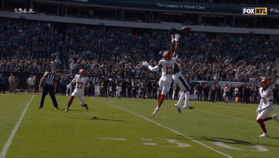 Football Player Number 15 Jumping To Catch Ball GIF