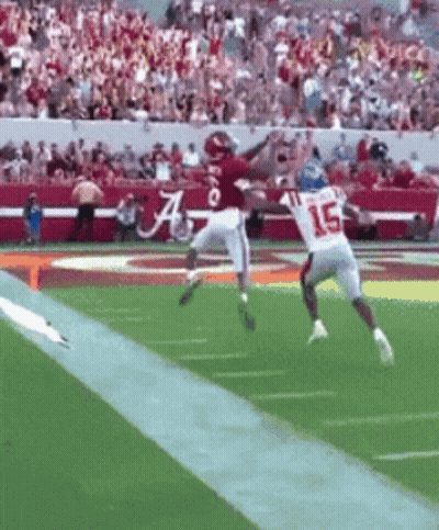 Football Player Number 15 Jumping To Catch Ball GIF