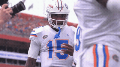 Football Player Number 15 Talks To Another Player GIF