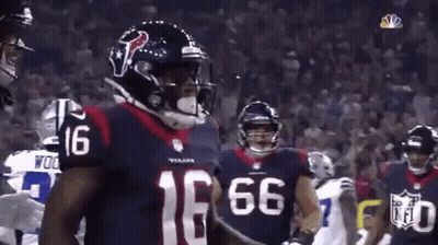 Football Player Number 16 Standing Before Crowd GIF