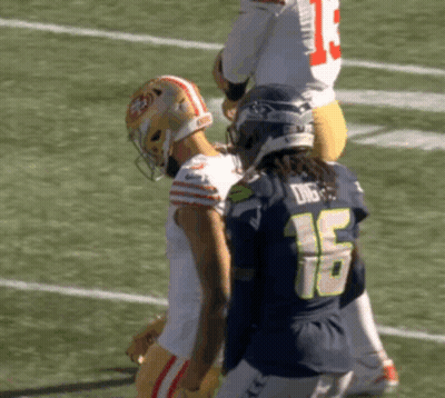 Football Player Number 16 Standing Next To Player GIF
