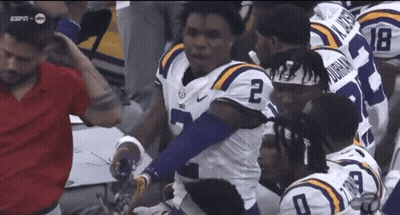 Football Player Number 2 Surrounded By Teammates GIF
