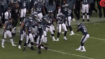 Football Player Number 21 On Field With Teammates GIF