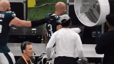 Football Player Number 23 Talking To Another Player GIF