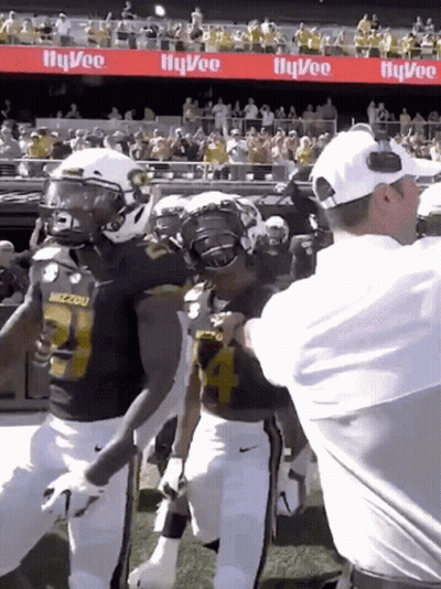 Football Player Number 24 Hugged By Coach GIF