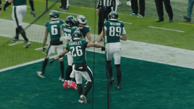 Football Player Number 26 Surrounded By Players GIF