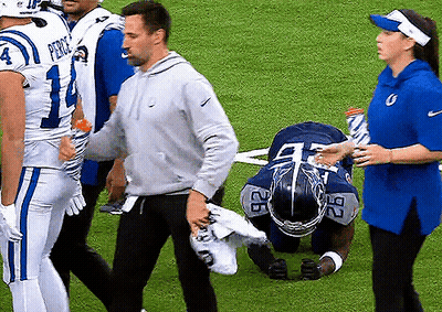 Football Player Number 27 Kneeling On Field GIF